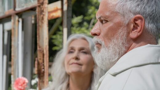 Close-up of an elderly couple outdoors, focusing on their profiles and expressions.