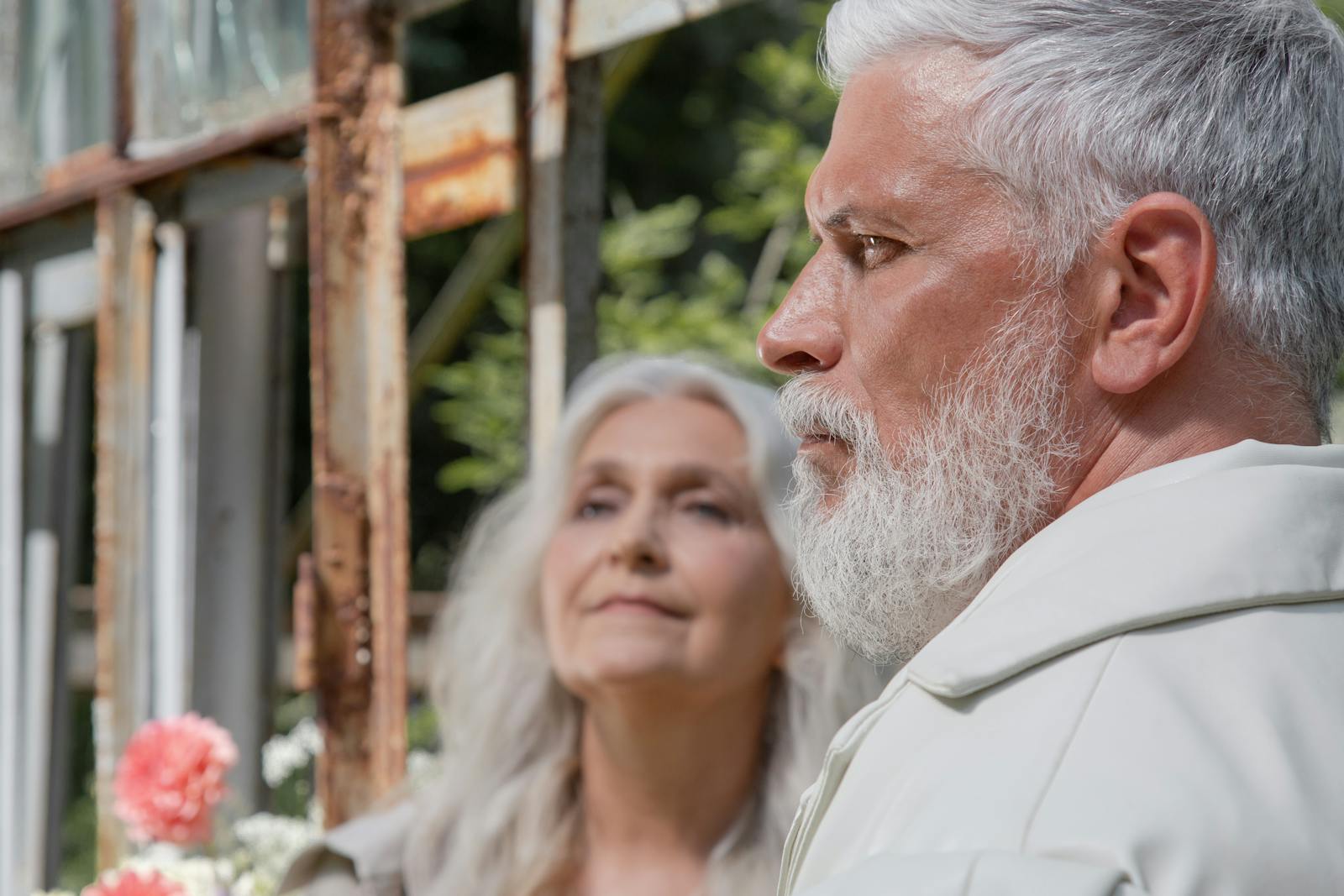 Close-up of an elderly couple outdoors, focusing on their profiles and expressions.