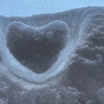 a heart shaped hole in the snow