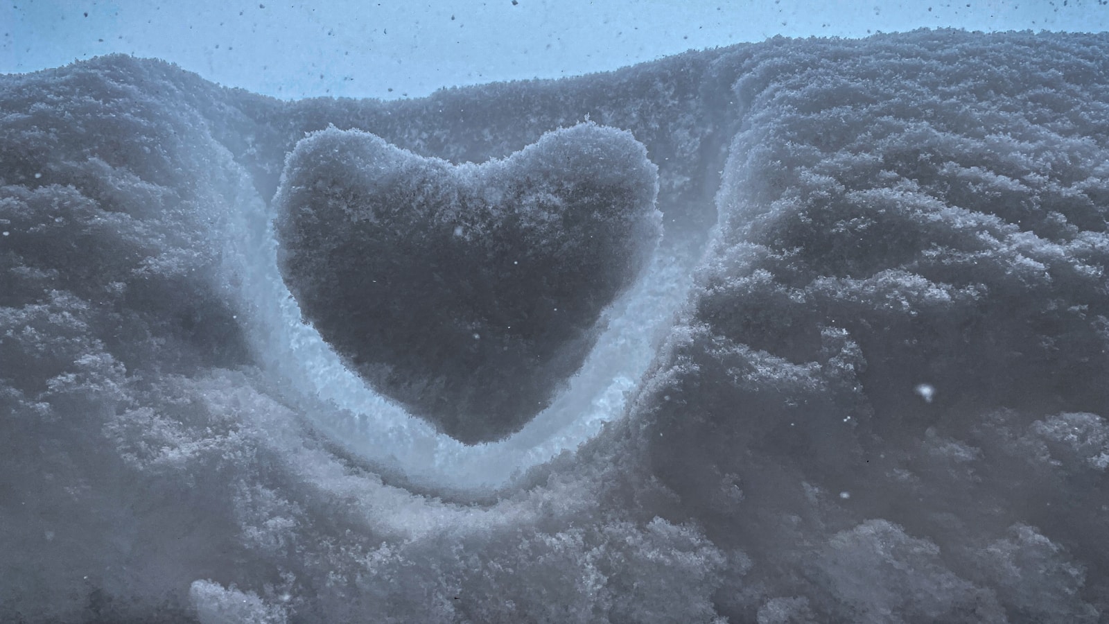 a heart shaped hole in the snow