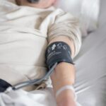 a man laying in a bed with a cast on his arm