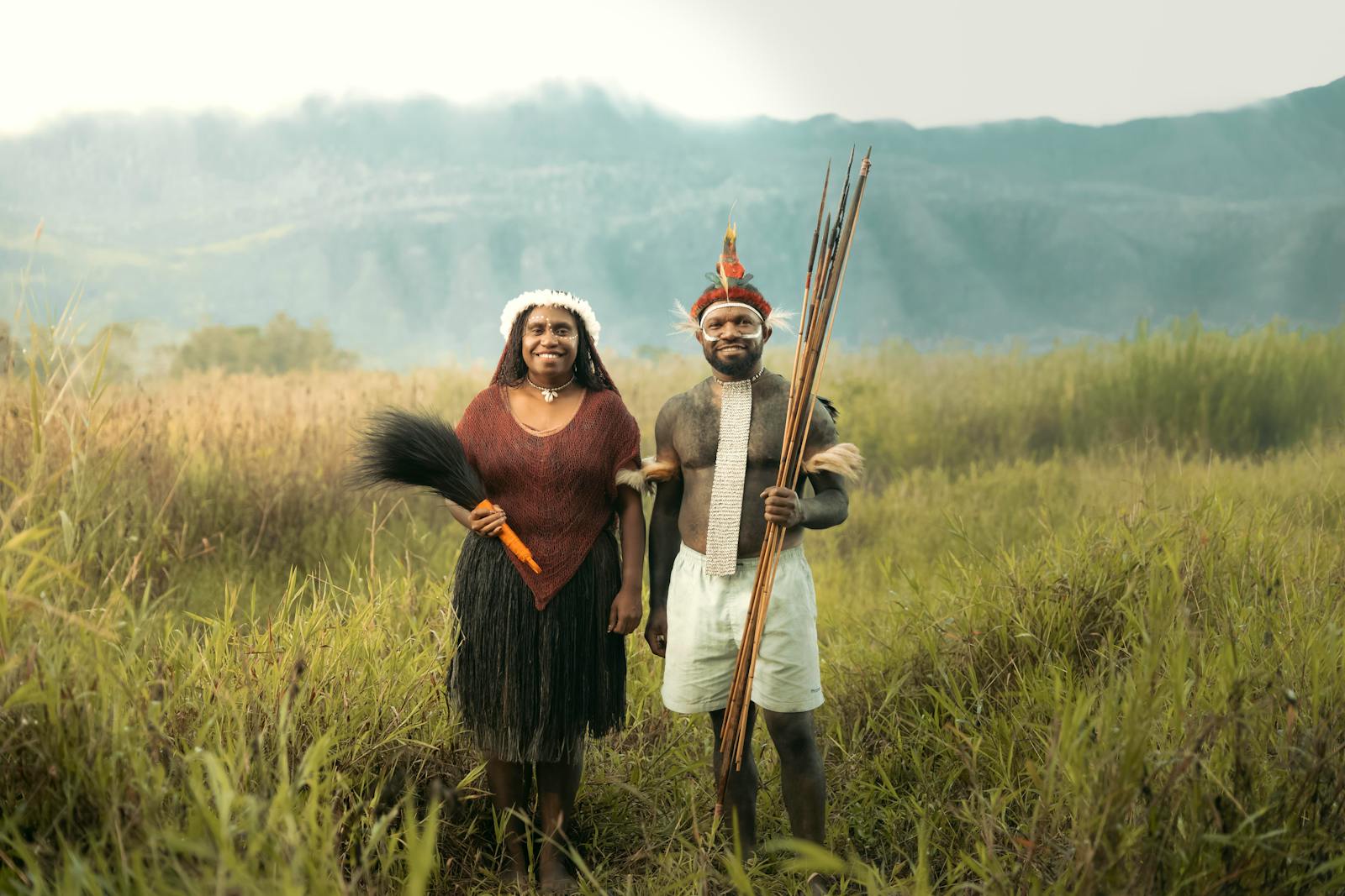 A man and woman standing in a field with long sticks highlight how men are usually taller than women.