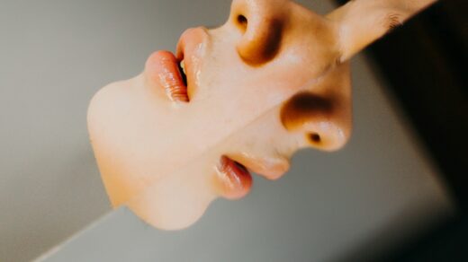 A woman's face is reflected in a mirror
