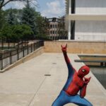 black quadcopter over person wearing Spider-Man costume
