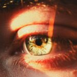 A close up of a person's eye with a blurry background