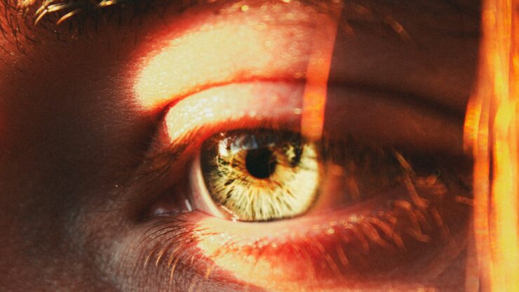 A close up of a person's eye with a blurry background