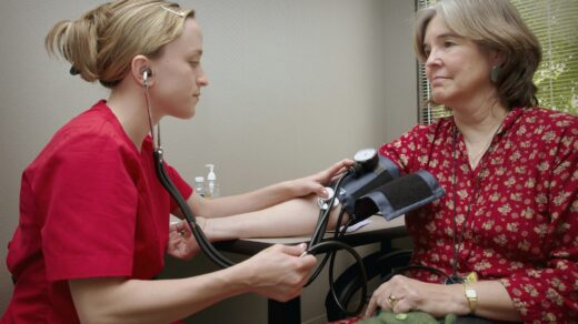 a woman with a stethoscope listening to a patient