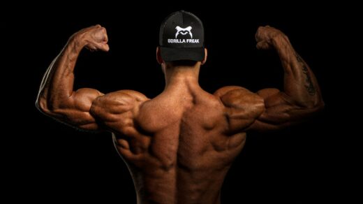 topless man wearing black and white cap