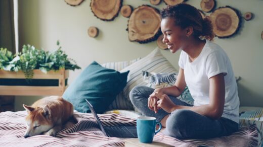 A woman works from home with pets.