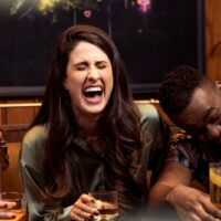 a group of people sitting around a table with drinks