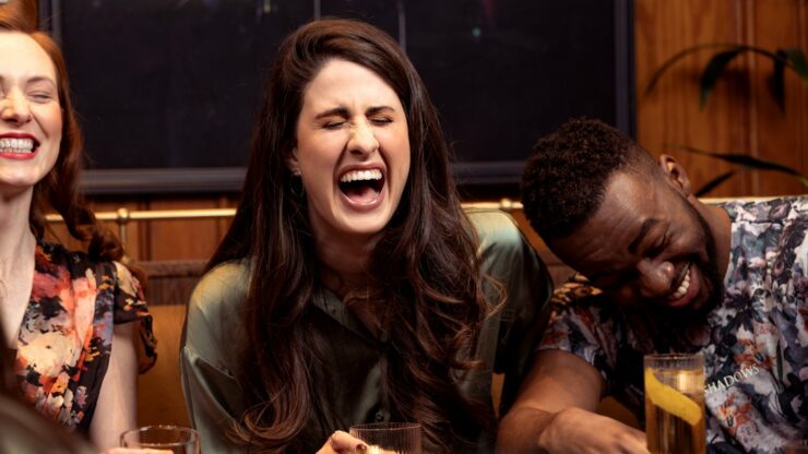 a group of people sitting around a table with drinks