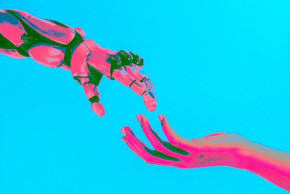 two hands reaching for a flying object in the sky