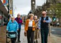 Group of seniors walking down a city street.