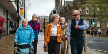 Group of seniors walking down a city street.