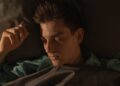 a man lying in bed sleeping