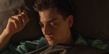 a man lying in bed sleeping