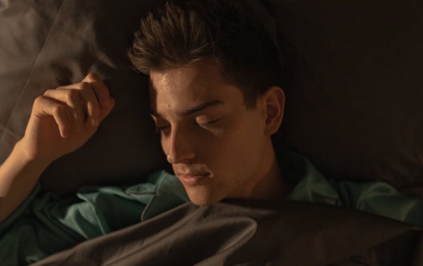 a man lying in bed sleeping