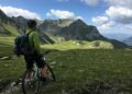 man riding bicycle on top of mountain