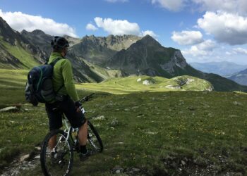 man riding bicycle on top of mountain
